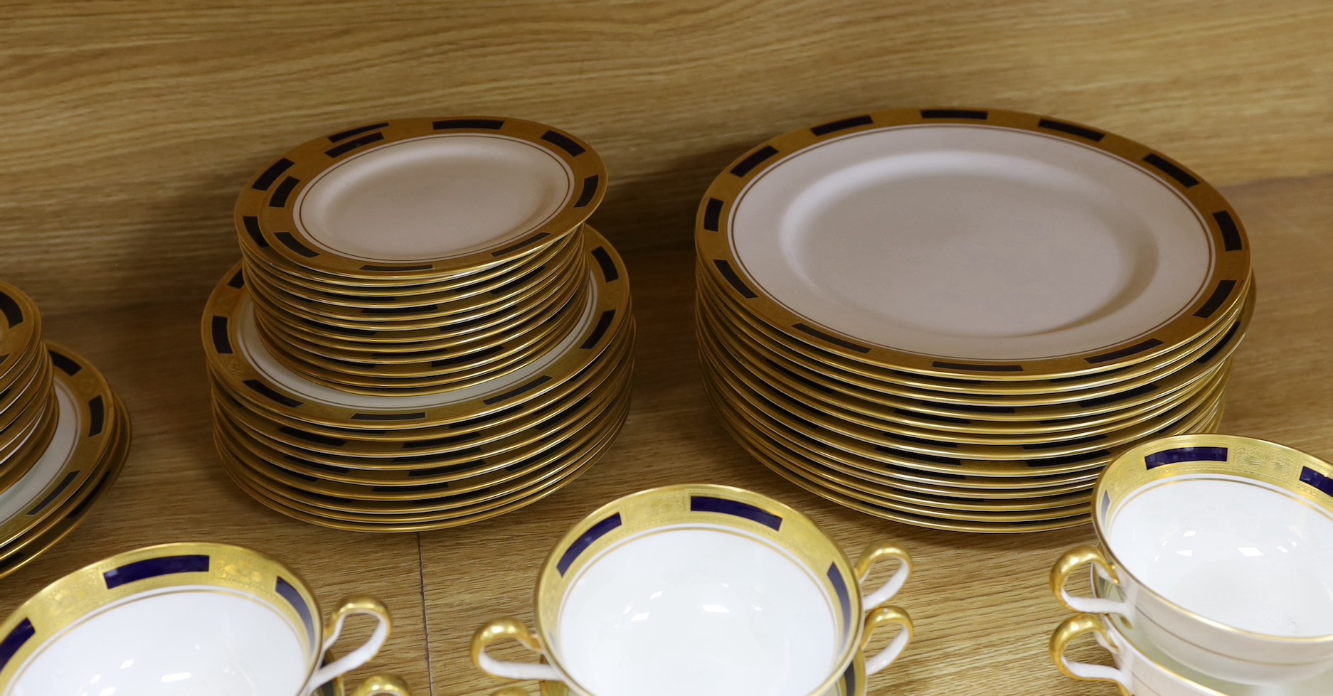 An Aynsley blue and gilt part dinner service